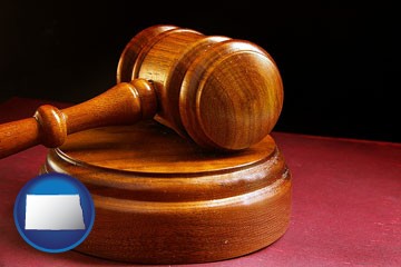an arbitrator's wooden gavel - with North Dakota icon